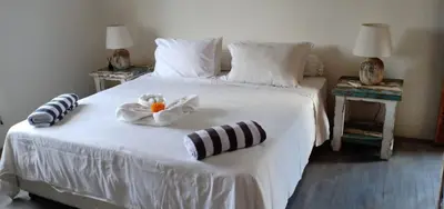 a bedroom with a white bed with two towels on it at Balinese Luxury in The Centre of Seminyak in Legian