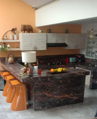 a kitchen with a counter with fruit on it at Balinese Luxury in The Centre of Seminyak in Legian