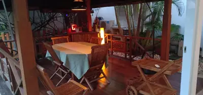 a table and chairs on the balcony of a house at Balinese Luxury in The Centre of Seminyak in Legian