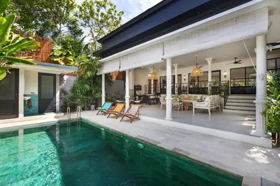 an exterior view of a house with a swimming pool at Villa Baruna Seminyak in Seminyak