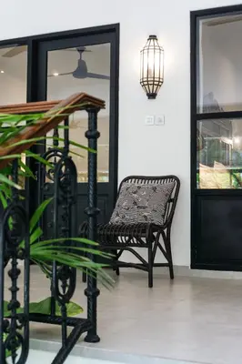 a black chair sitting in front of a door at Villa Baruna Seminyak in Seminyak