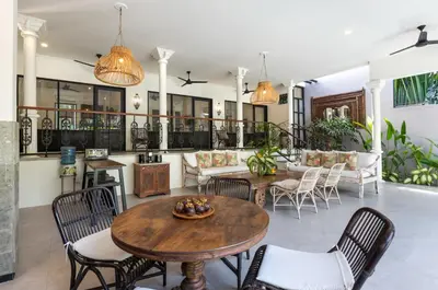 a living room with a table and chairs at Villa Baruna Seminyak in Seminyak