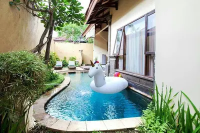 a swimming pool with an inflatable animal in a house at Clasic Private Pool Villa in Seminyak in Seminyak