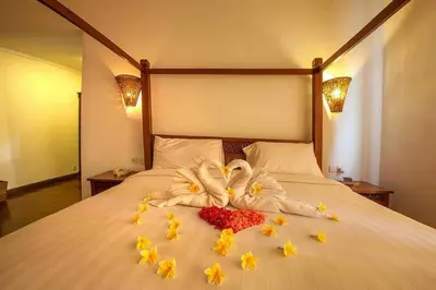 two swans made out of flowers on a bed at Clasic Private Pool Villa in Seminyak in Seminyak