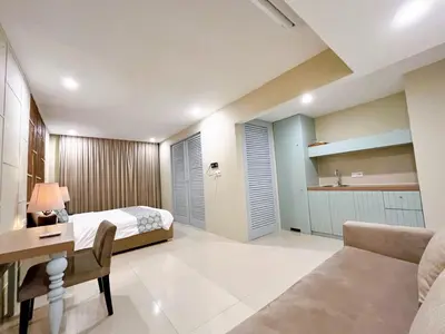 a bedroom with a bed and a desk at Astana Residence in Seminyak