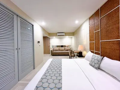 a hotel room with a bed and a couch at Astana Residence in Seminyak