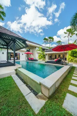 a swimming pool in the backyard of a house at Exquisite 4BD Luxury Villa in the Heart of Berawa in Canggu