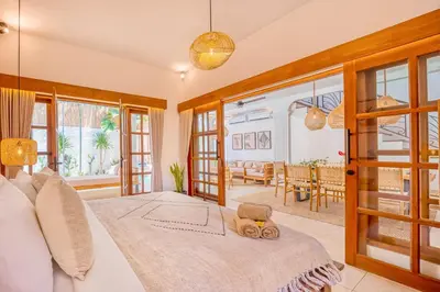 a bedroom with a bed and a dining room at Villa San Diego: Brand New 4BDR in Seminyak