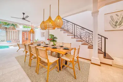 a dining room with a wooden table and chairs at Villa San Diego: Brand New 4BDR in Seminyak