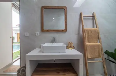 a bathroom with a white sink and a mirror at Simple & Magical Villas Almaya 2 in Canggu