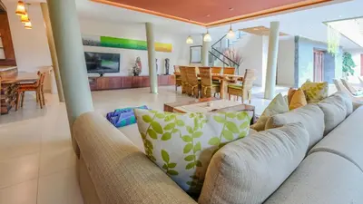 a living room with a couch and a table at The Kasih Villas & Spa in Seminyak