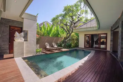 a swimming pool in the backyard of a house at The Kasih Villas & Spa in Seminyak