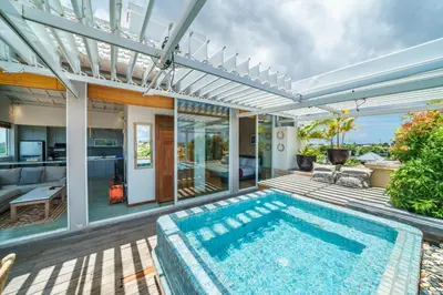an indoor swimming pool in a house with a patio at Private Penthouse with Sunset Views Central Seminyak in Seminyak