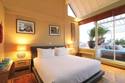 a bedroom with a large bed and a large window at Private Penthouse with Sunset Views Central Seminyak in Seminyak