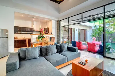 a living room with a couch and a table at Villa O'Anne in Seminyak
