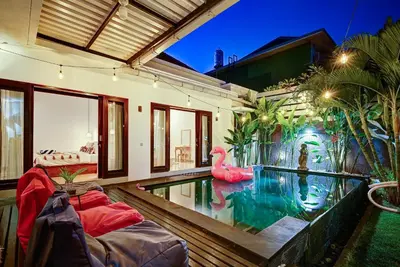 a house with a swimming pool with a pink flamingo at Villa O'Anne in Seminyak