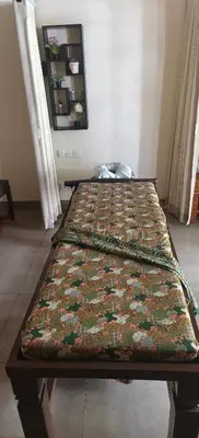 a bed in a room with a blanket on it at The Bay Sunflower Apartment in Nusa Dua