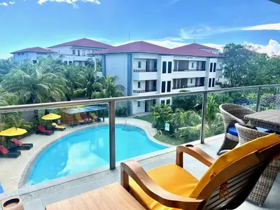 a view of a balcony with a swimming pool at The Bay Sunflower Apartment in Nusa Dua