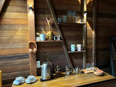 a table with a tea kettle on top of it at Bali Cozy Bungalows, Nusa Dua Benoa in Nusa Dua