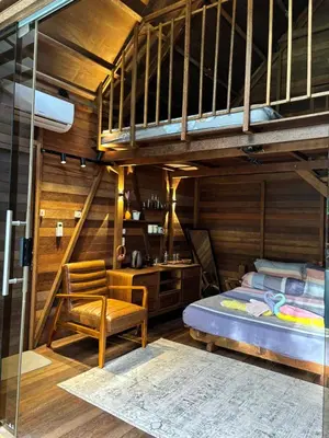 a bedroom with a bunk bed and a chair at Bali Cozy Bungalows, Nusa Dua Benoa in Nusa Dua