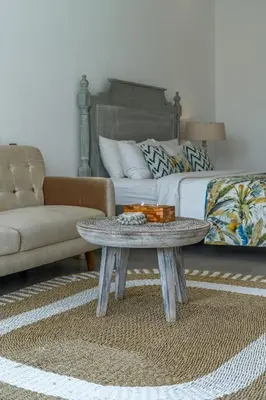 a living room with a couch and a coffee table at Villa Athalla - Elegant 3BR Near Berawa Beach! in Canggu