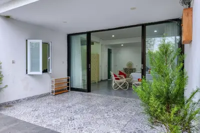 a room with sliding glass doors and a patio at Villa Emilia Seminyak by Nagisa Bali in Kerobokan