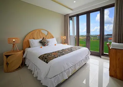 a bedroom with a large bed and a large window at Villa Emilia Seminyak by Nagisa Bali in Kerobokan