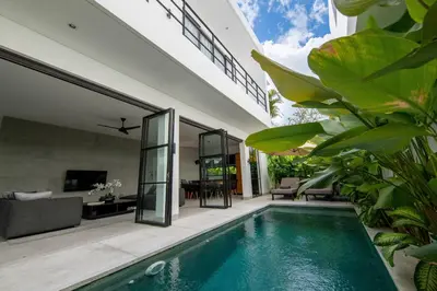 a swimming pool in a house with a living room at Two-Bedroom Pool Villa at Anwa Residences in Canggu