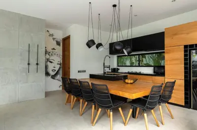 a kitchen and dining room with a wooden table and chairs at Two-Bedroom Pool Villa at Anwa Residences in Canggu