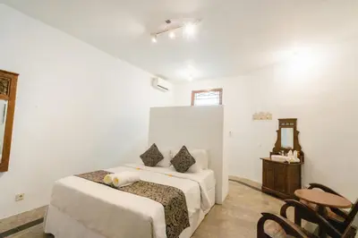 a bedroom with two beds and a table and chairs at 5 Bedroom Villa Etnik in Seminyak with Big Garden and Private Pool in Seminyak