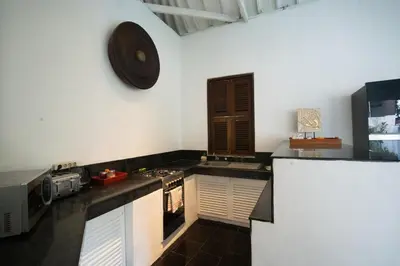 a kitchen with a stove and a clock on the wall at 5 Bedroom Villa Etnik in Seminyak with Big Garden and Private Pool in Seminyak