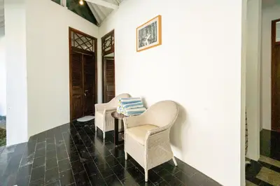 two chairs and a table on a porch at 5 Bedroom Villa Etnik in Seminyak with Big Garden and Private Pool in Seminyak