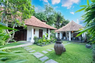 a courtyard of a house with a large vase in the yard at 5 Bedroom Villa Etnik in Seminyak with Big Garden and Private Pool in Seminyak
