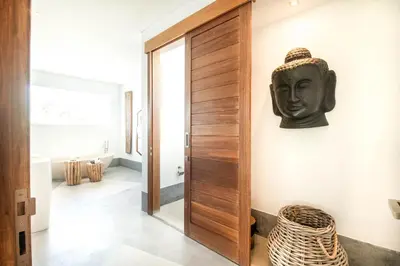 a room with a door with a head on the wall at New Brawah 5 BR Villa 200m to Finns Beach Club in Canggu