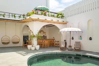 a house with a swimming pool and a patio at Mysa Boutique Hotel in Seminyak