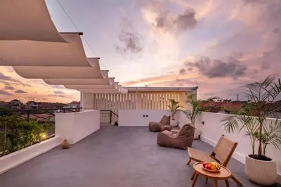 a balcony with a view of a sunset at Mysa Boutique Hotel in Seminyak