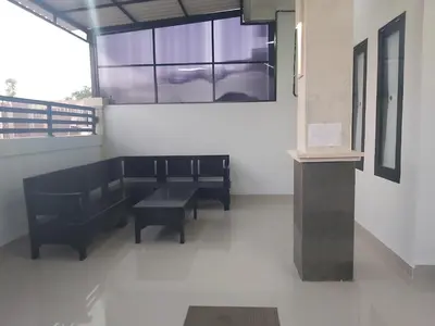 a group of benches in a room with a window at Chandra's House in Denpasar