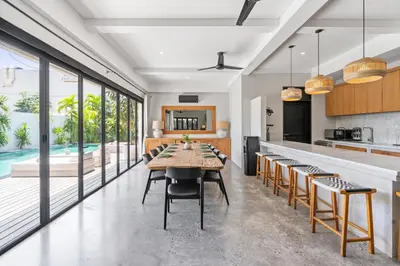 a kitchen and dining room with a table and chairs at Abu Villa by Betterplace in Canggu