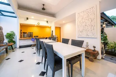 a dining room with a long table and chairs at Little Boutique Hotel No 101 in Canggu