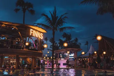 a pool at a theme park at night at Little Boutique Hotel No 101 in Canggu