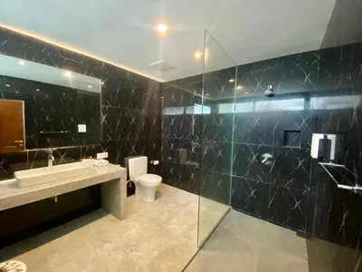 a bathroom with a sink and a toilet and a shower at Mila's Villa in Legian