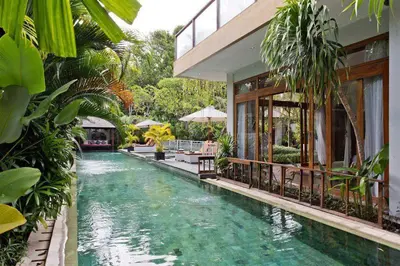 a swimming pool in the middle of a house at Zolina Villa 4 Bedrooms in Kerobokan