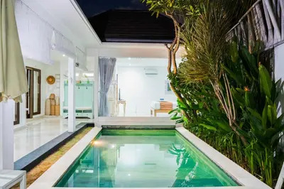 a swimming pool in a villa with a house at Villa between seminyak & canggu in Seminyak