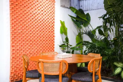 a wooden table with two chairs and a tableasteryasteryasteryasteryasteryasteryastery at Villa between seminyak & canggu in Seminyak