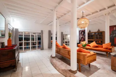 a large living room with couches and a chandelier at Seminyak Villa Kubuku in Seminyak