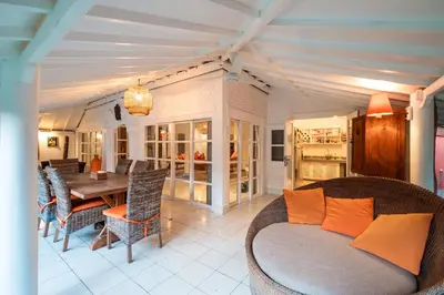 a living room with a bed and a dining room at Seminyak Villa Kubuku in Seminyak