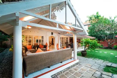 an outdoor living room with a large glassconservatory at Seminyak Villa Kubuku in Seminyak