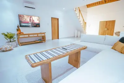 a living room with a white couch and a table at Villa Amil Seminyak in Seminyak