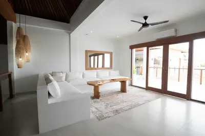 a living room with a white couch and a table at Villa Amil Seminyak in Seminyak