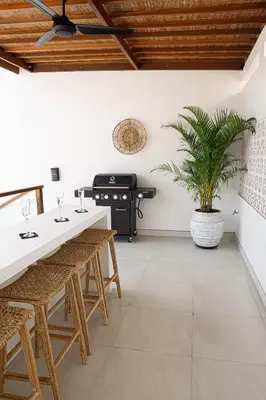 a kitchen with a table and chairs and a grill at Villa Amil Seminyak in Seminyak
